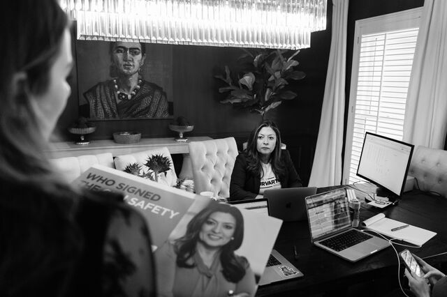 Laura Murvartian sits at her desk while meeting with her finance director at home. 