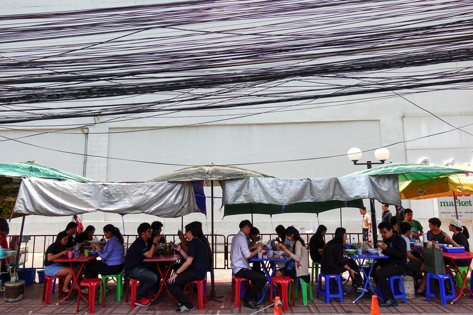 People eat their lunch at a street food shop in Bangkok, Thailand.