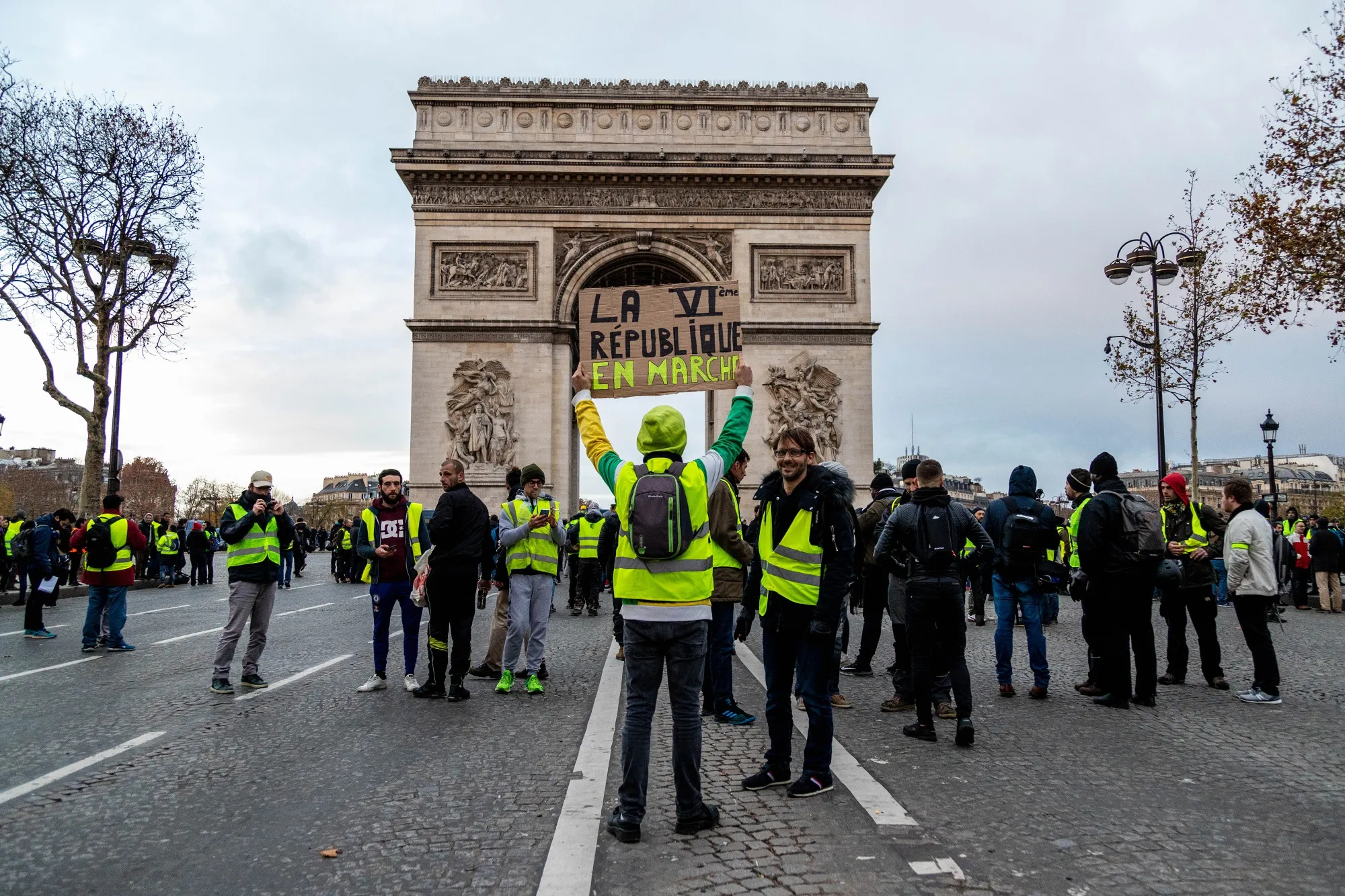 A demonstrator holds up a placard during a yellow vests protest at the Arc de Triomph in Paris on Dec. 8, 2018.