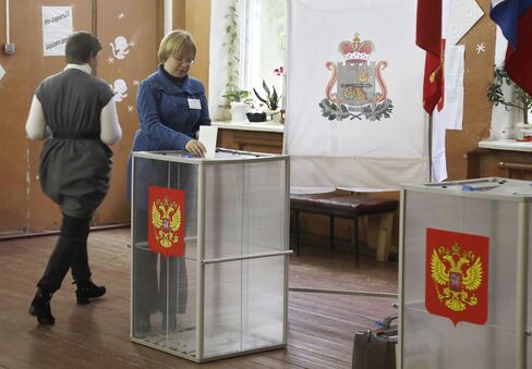 A woman casts her ballot at a polling station near Smolensk on Sept. 18.