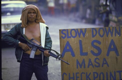An Alsa Masa member guards a checkpoint in Davao in 1987.