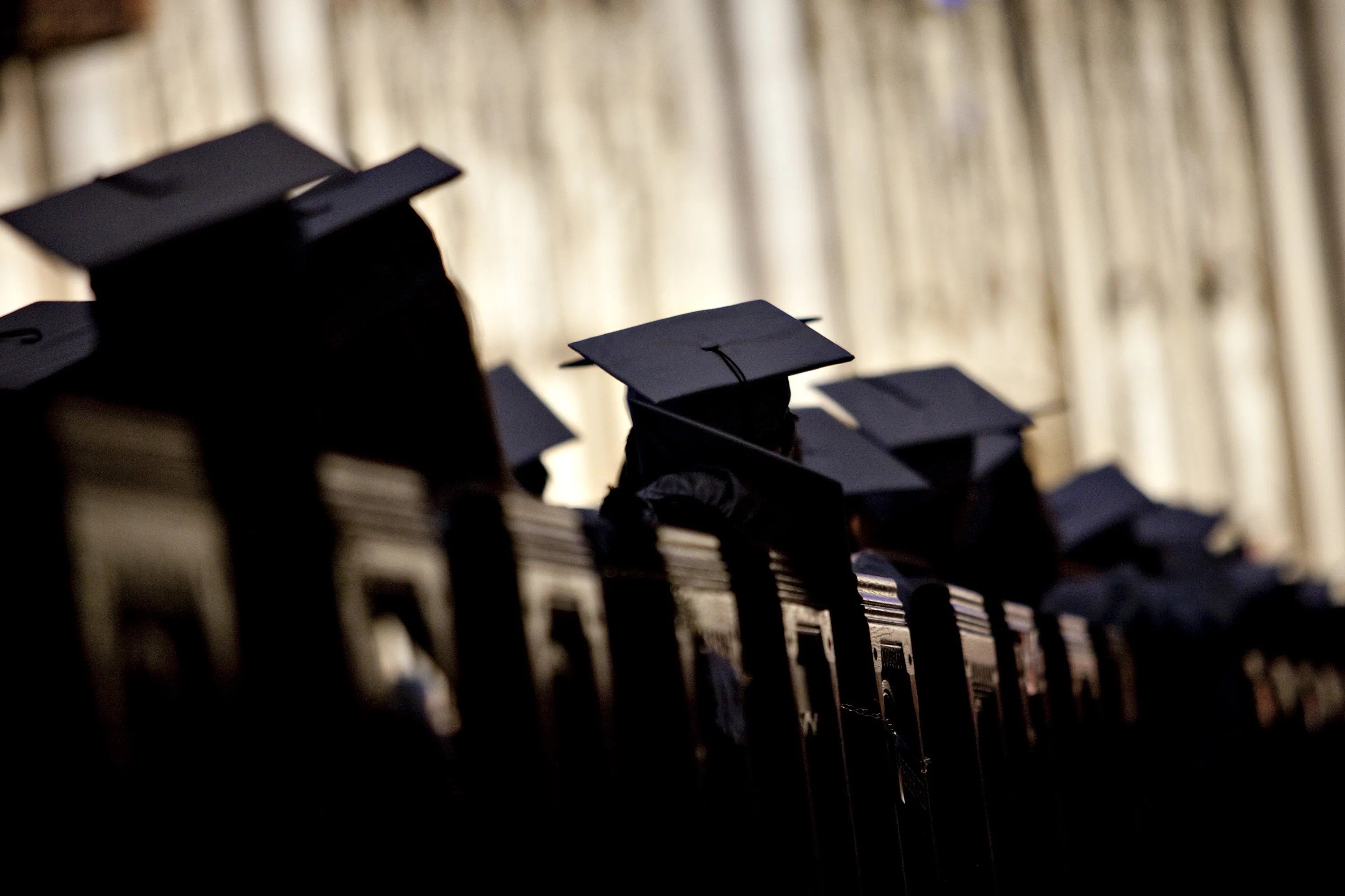 Graduates listen to a commencement speaker during a university graduation ceremony.&nbsp;