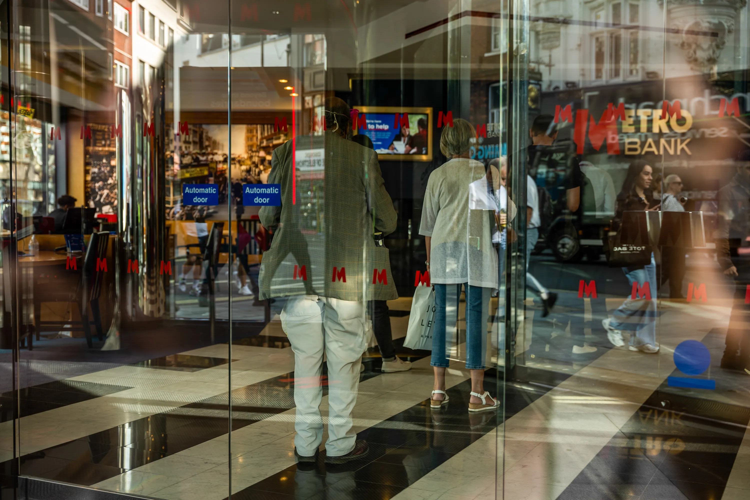 Customers queue inside a Metro Bank&nbsp;branch in London, UK.