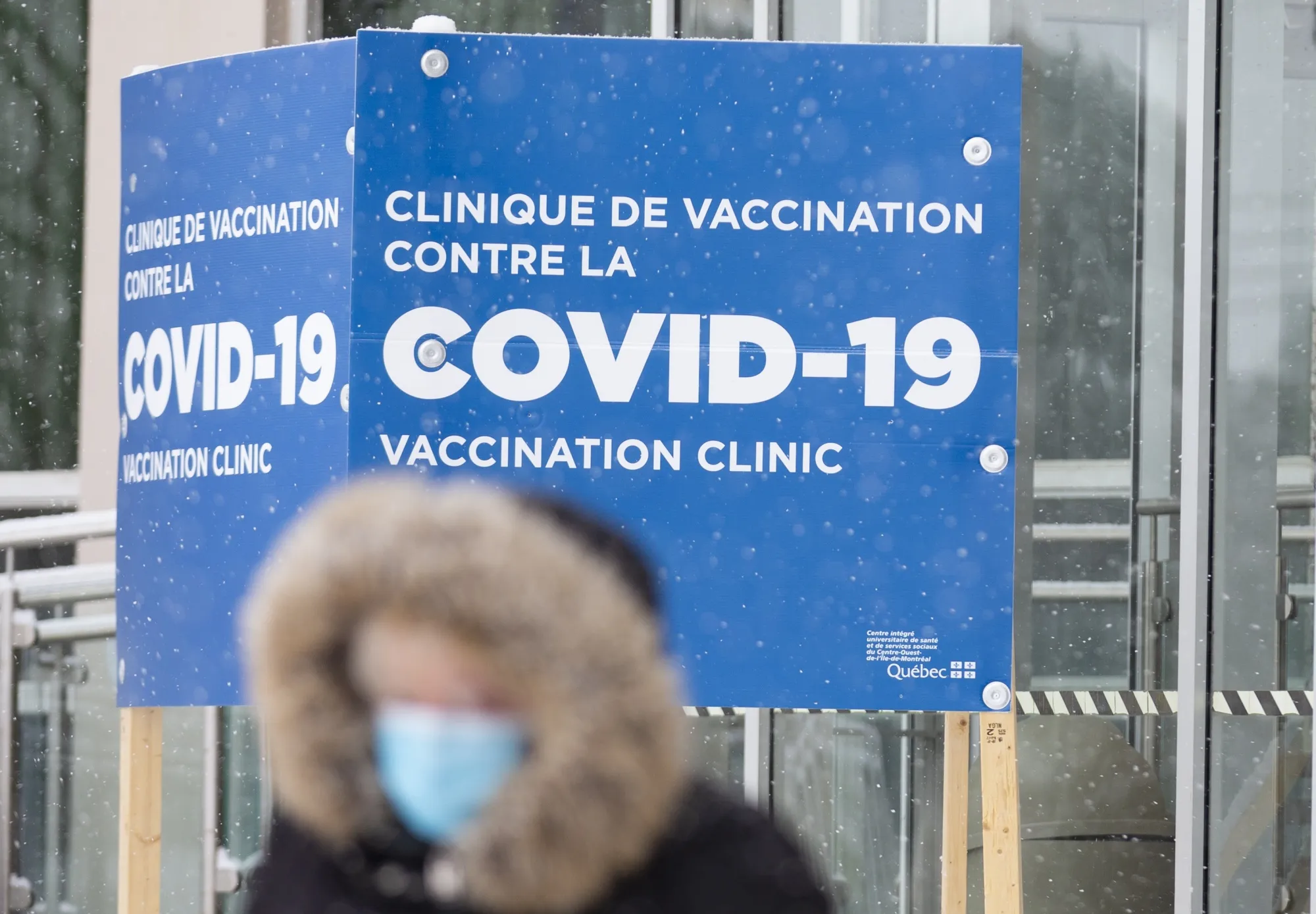 A pedestrian passes in front of a Covid-19 vaccination clinic in Montreal last year.