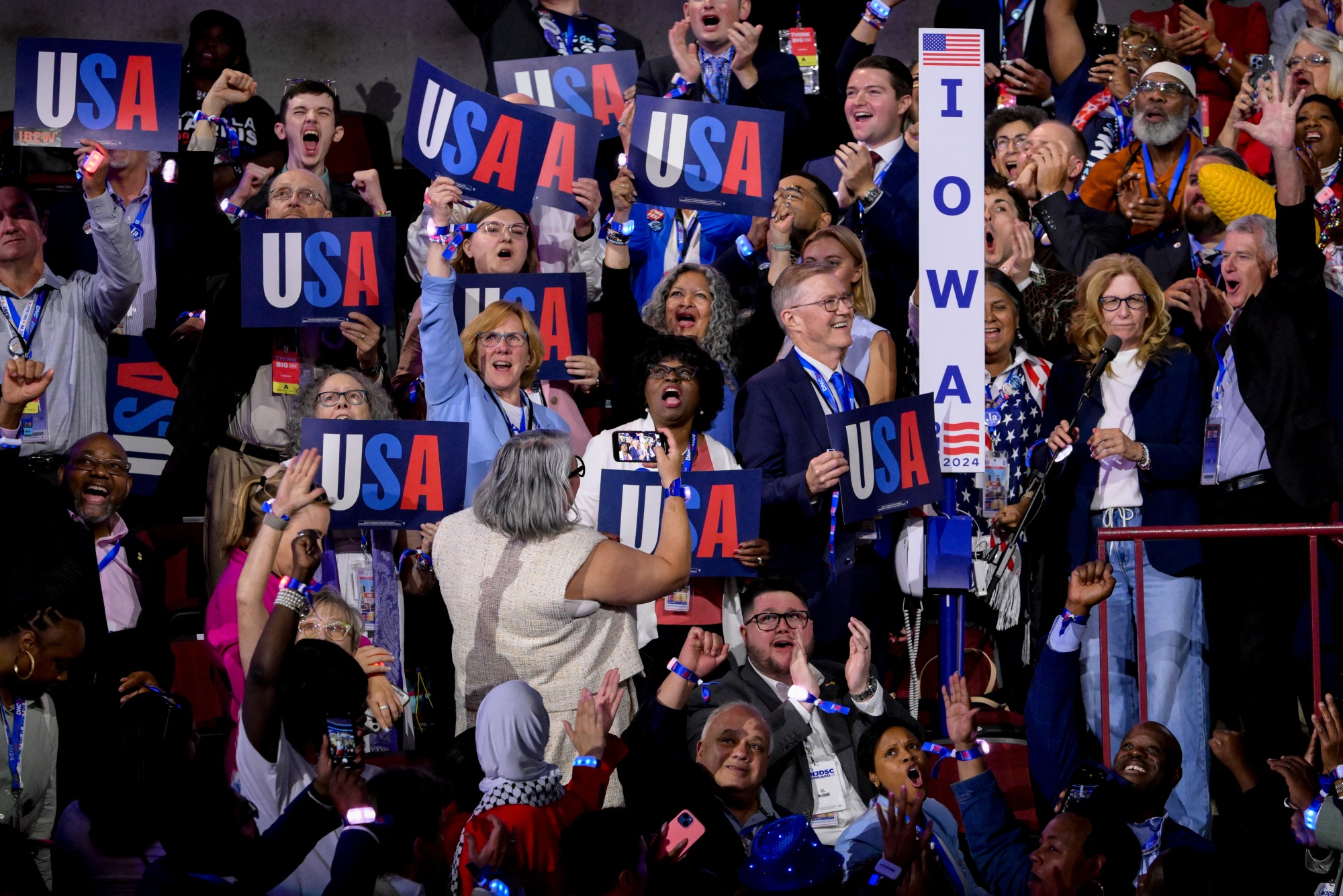 Iowa delegates cheer during a ceremonial roll call vote during the Democratic National Convention (DNC) 