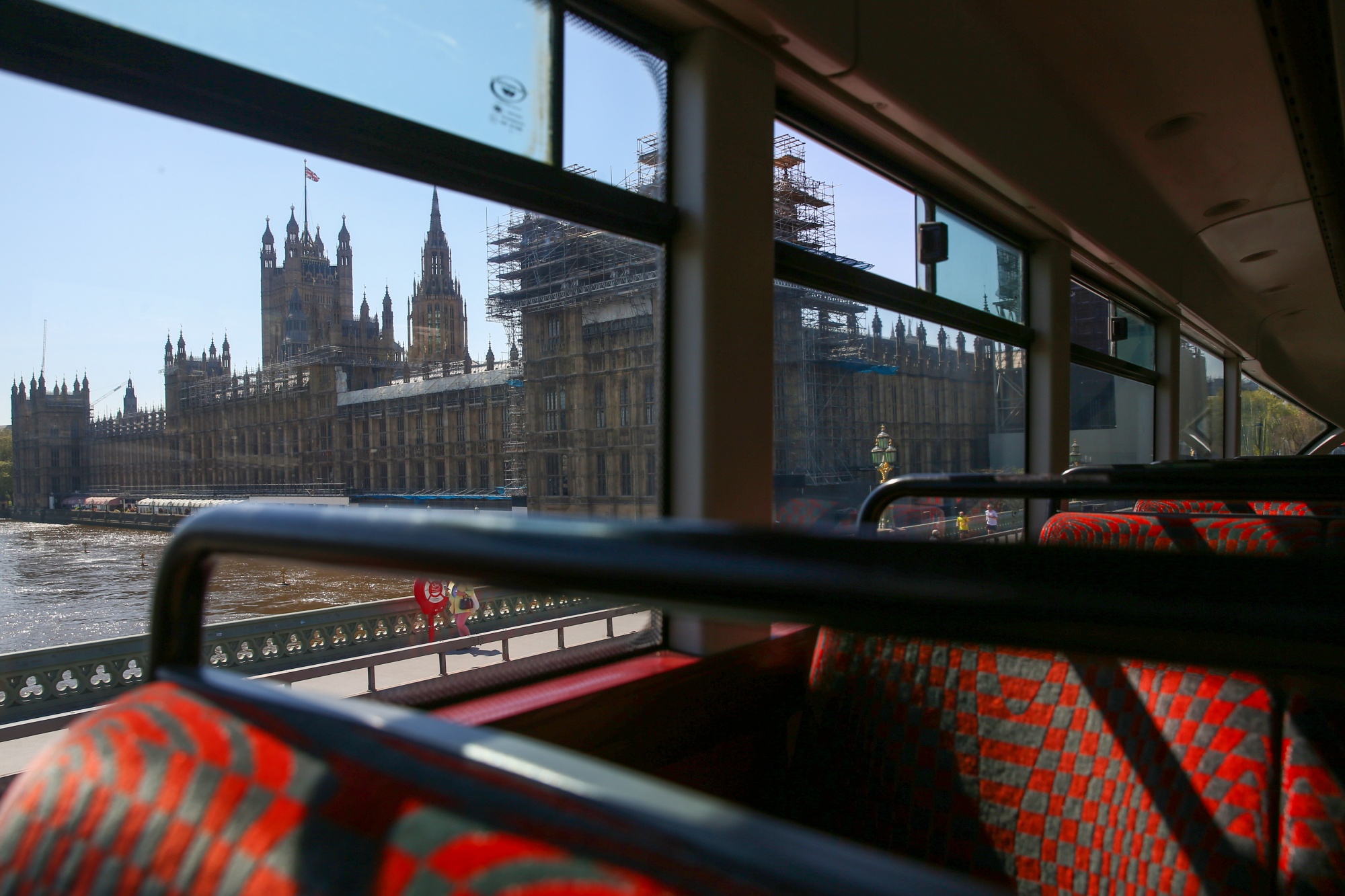 The Houses of Parliament stand in this view from inside a bus in London on April 22.