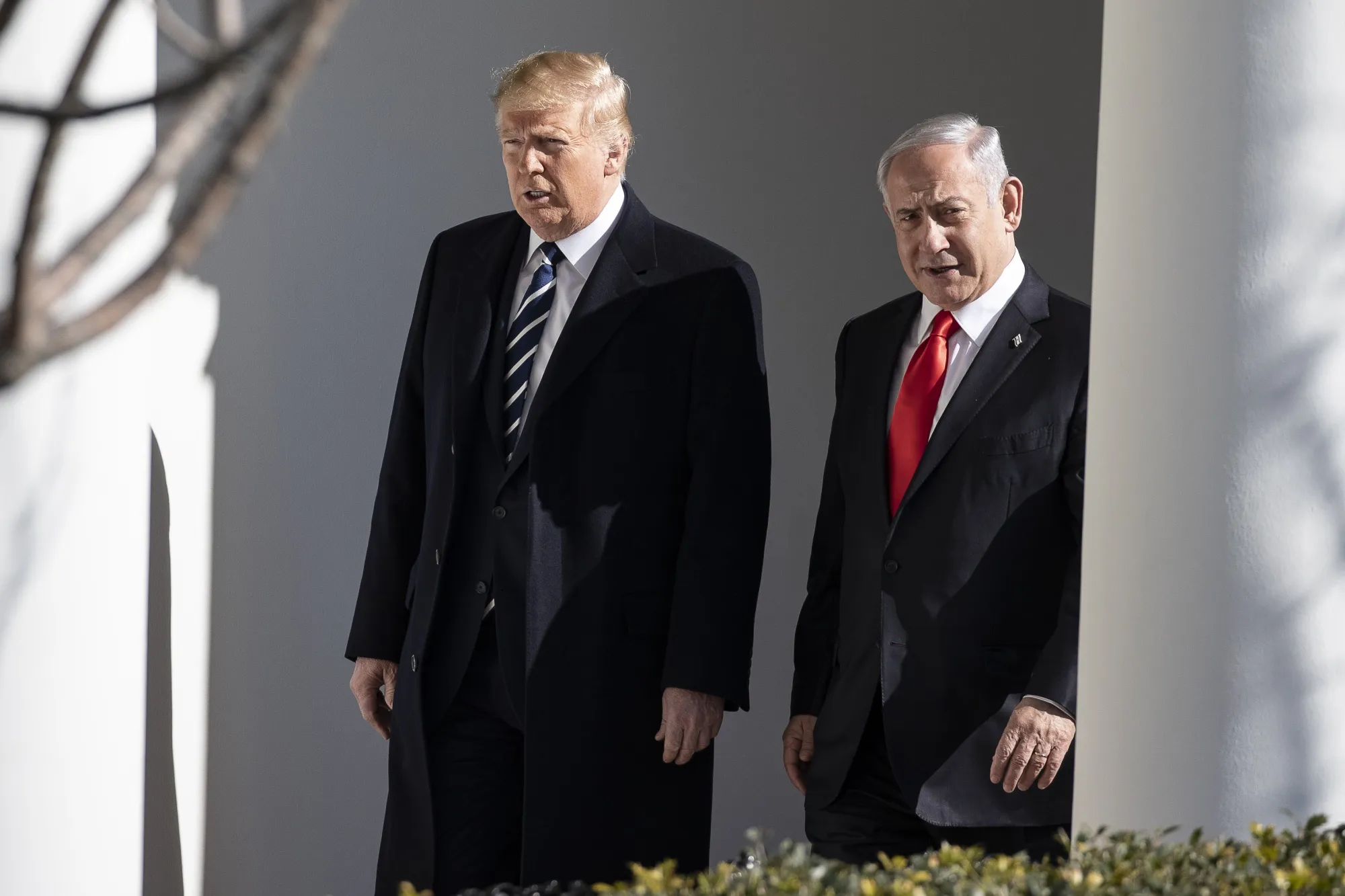U.S. President Donald Trump walks with Benjamin Netanyahu in Washington, on Jan. 27.