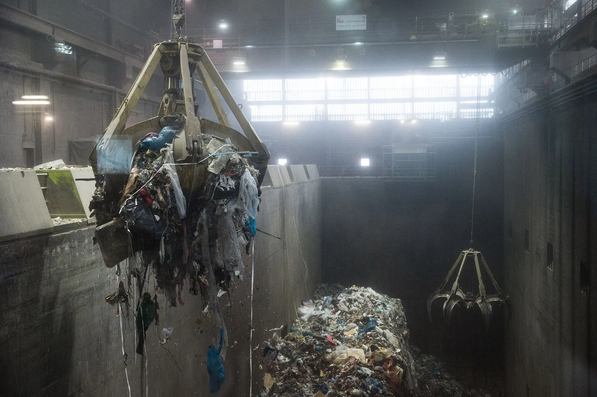 Two grapplers transport trash to the incinerator at a waste station near Stuttgart, Germany.