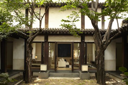 Two fiddlewood trees flank the courtyard of the guest bedroom.