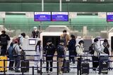 Travelers at Shanghai Airport As China's Top Medical Adviser Says Omicron's Risks Same as Flu