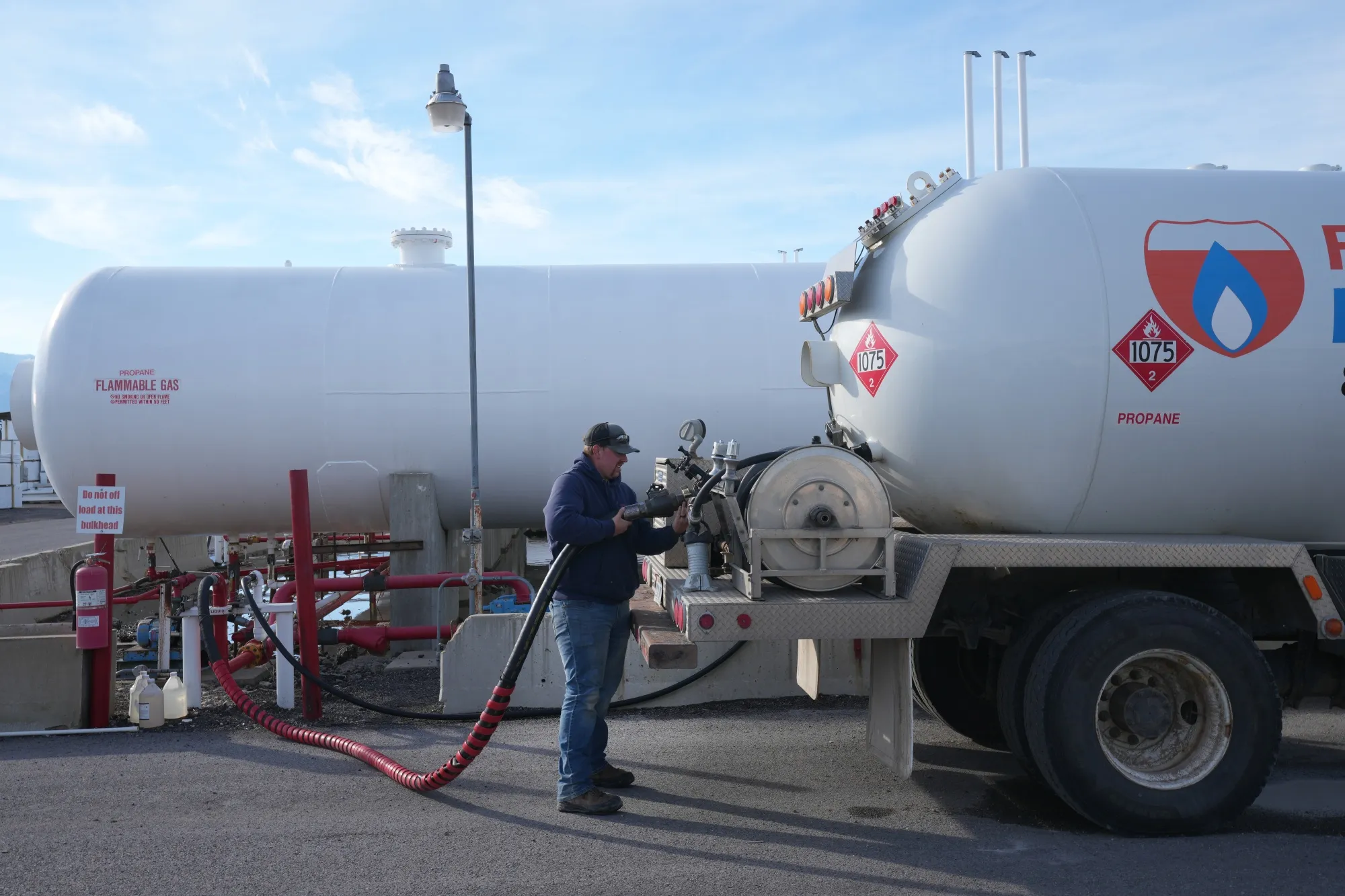 A worker fills a propane deliver truck at propane facility in Springville, Utah.