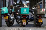 A Deliveroo rider&nbsp;waits for food orders in London.&nbsp;