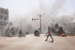 Smoke rises from burning barricades during protests against president Marc Christian Kabore, in Ouagadougou, Burkina Faso, on Jan. 23.