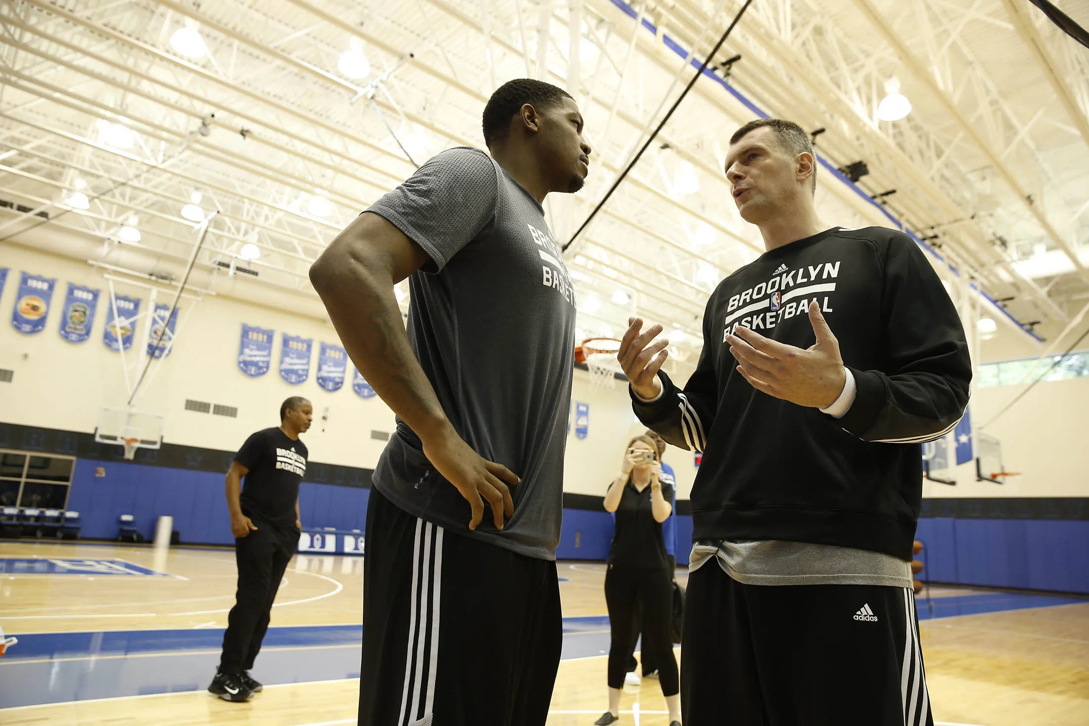 Mikhail Prokhorov and Brooklyn Nets player Joe Johnson chats during training camp.
