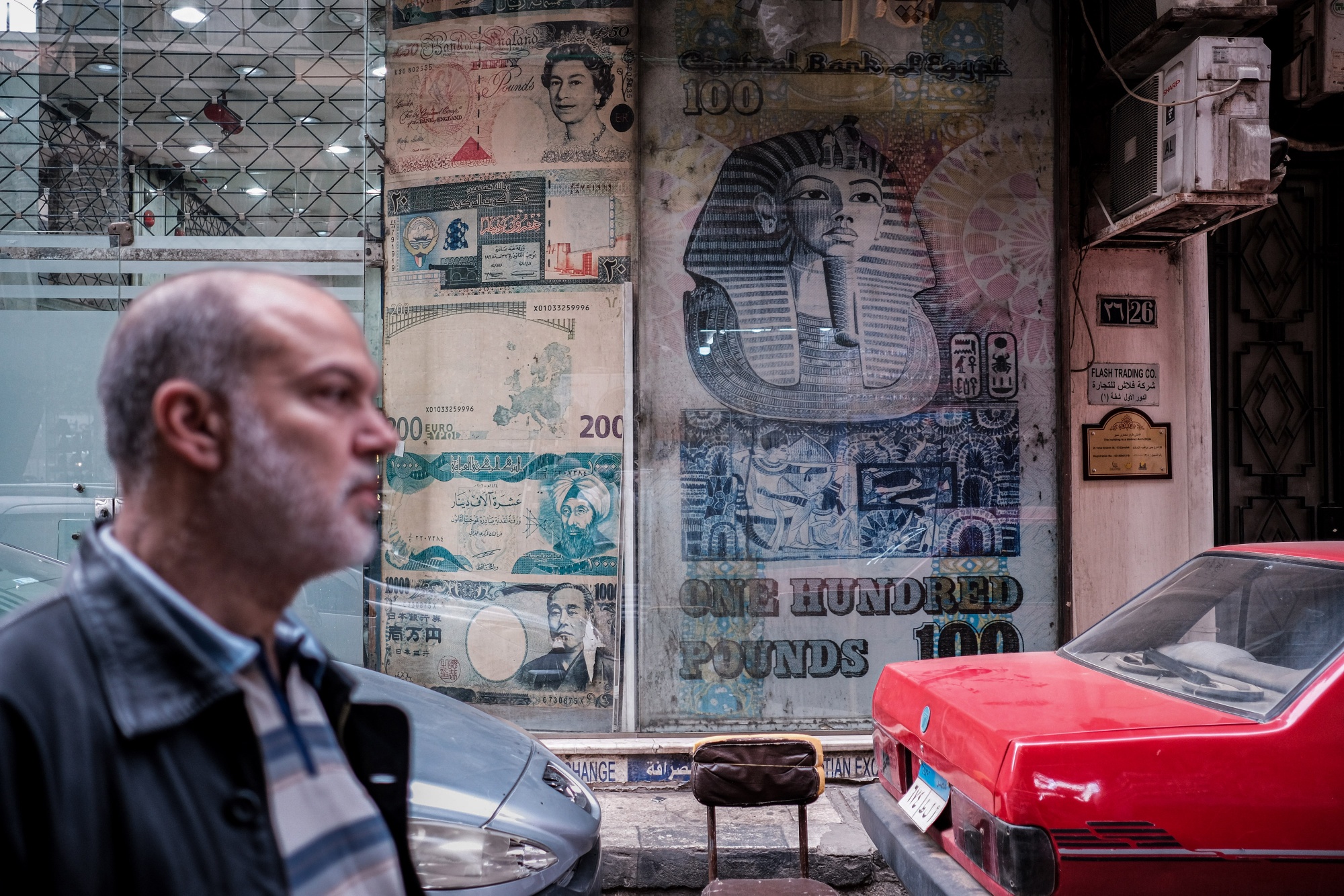 Images of Egyptian and foreign currency banknotes in the window of a currency exchange bureau in Cairo, Egypt.