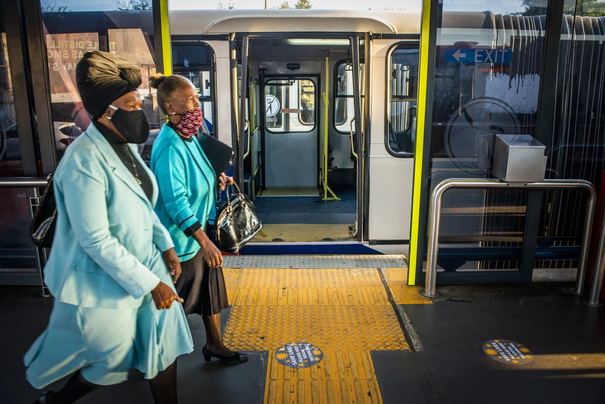 Commuters walk by social distancing markers on the ground at a bus station in Johannesburg, South Africa, on May 14.