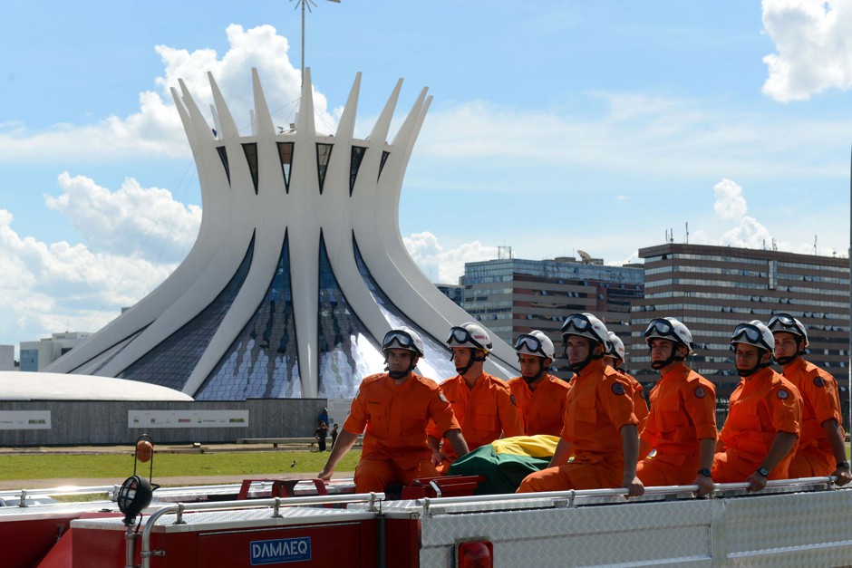 A fire truck escorting the coffin containing the remains of Brazilian architect Oscar Niemeyer drives past the Metropolitan Cathedral, on its way to the Planalto presidential palace, in Brasilia, Brazil, Thursday, Dec. 6, 2012.