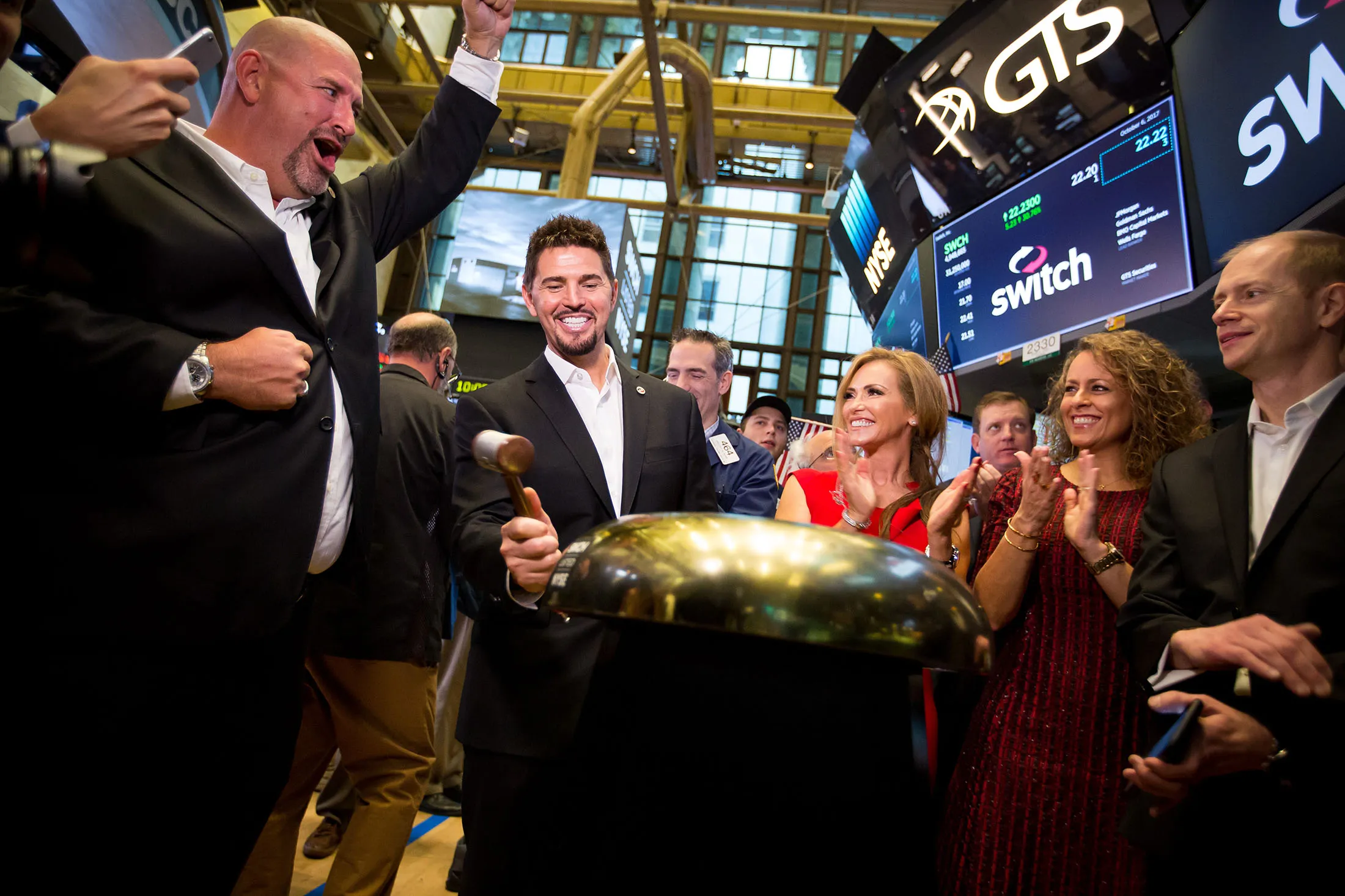 Rob Roy, founder and chief executive officer of Switch Inc., center left, rings a ceremonial bell during the company's initial public offering (IPO) on the floor of the New York Stock Exchange on&nbsp; Oct. 6, 2017.