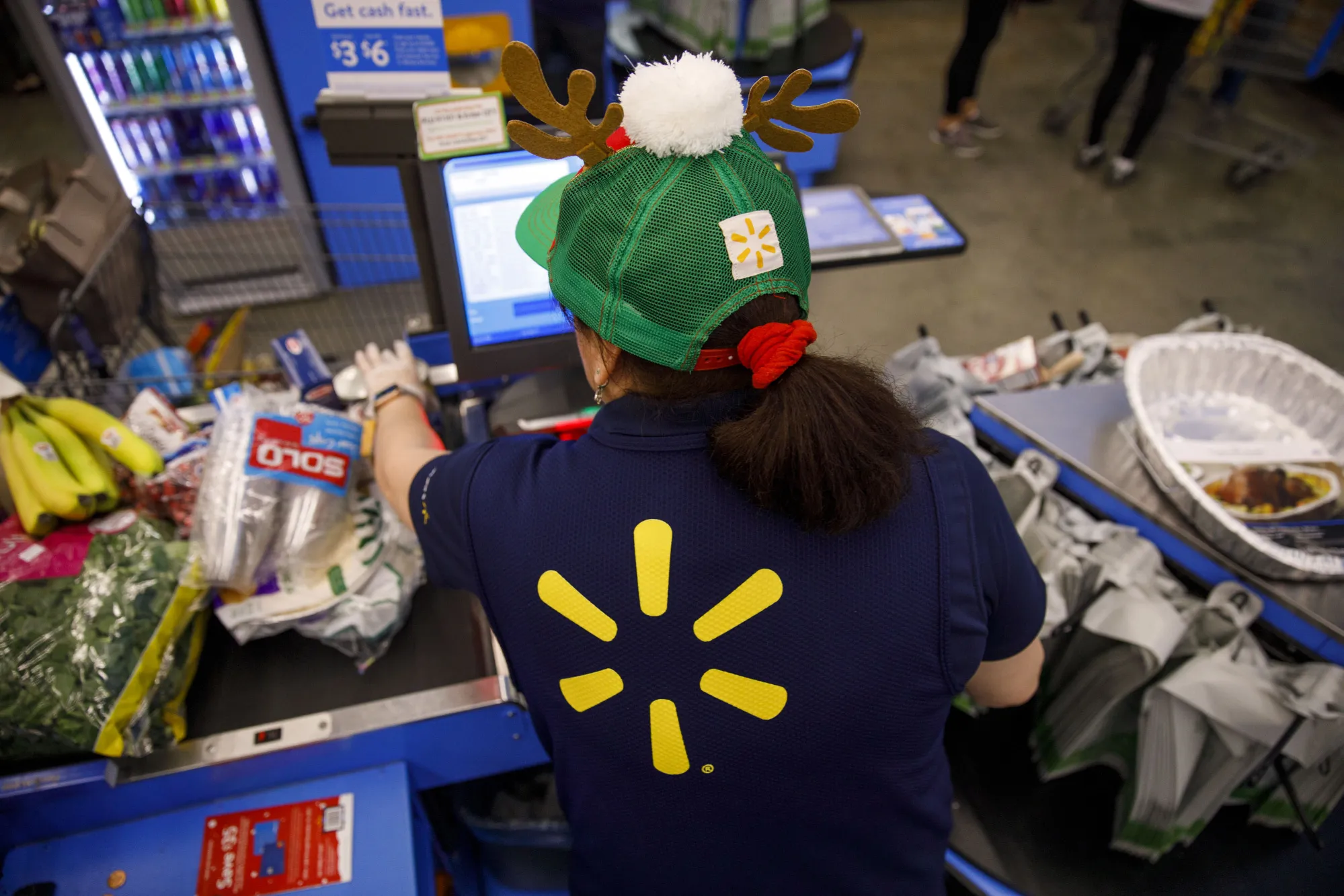A cashier scans items for a customer at a Wal-Mart Stores Inc. location in Burbank, California, U.S., on Thursday, Nov. 16, 2017. Black Friday, the day after Thanksgiving, marks the traditional start to the U.S. holiday shopping season.