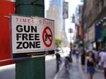 Signs announcing the&nbsp;&quot;gun-free zone&quot; area in&nbsp;Times Square, New York.