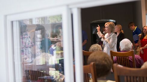 Former Secretary of State Hillary Clinton speaks to guests at a house party on July 26, 2015, in Carroll, Iowa.