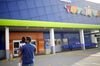 Customers walk towards the entrance to a Toys R Us Inc. retail store in Louisville, Kentucky, U.S..