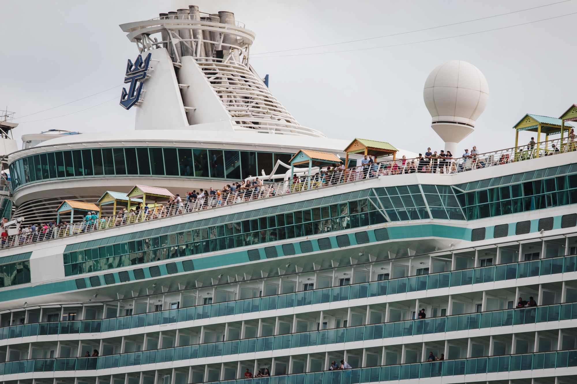 Passengers stand on board the Royal Caribbean Cruises Navigator Of The Seas cruise ship at the Port of Miami on&nbsp;March 9,.