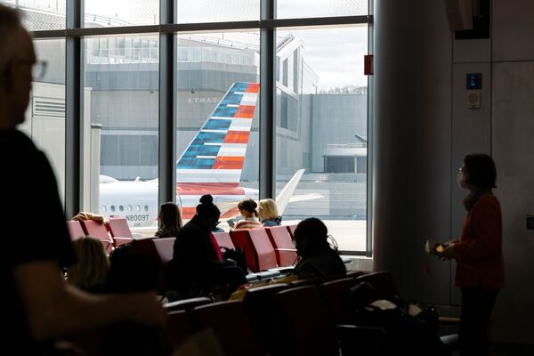 Passengers wait to board an American Airlines flight at LaGuardia Airport. 