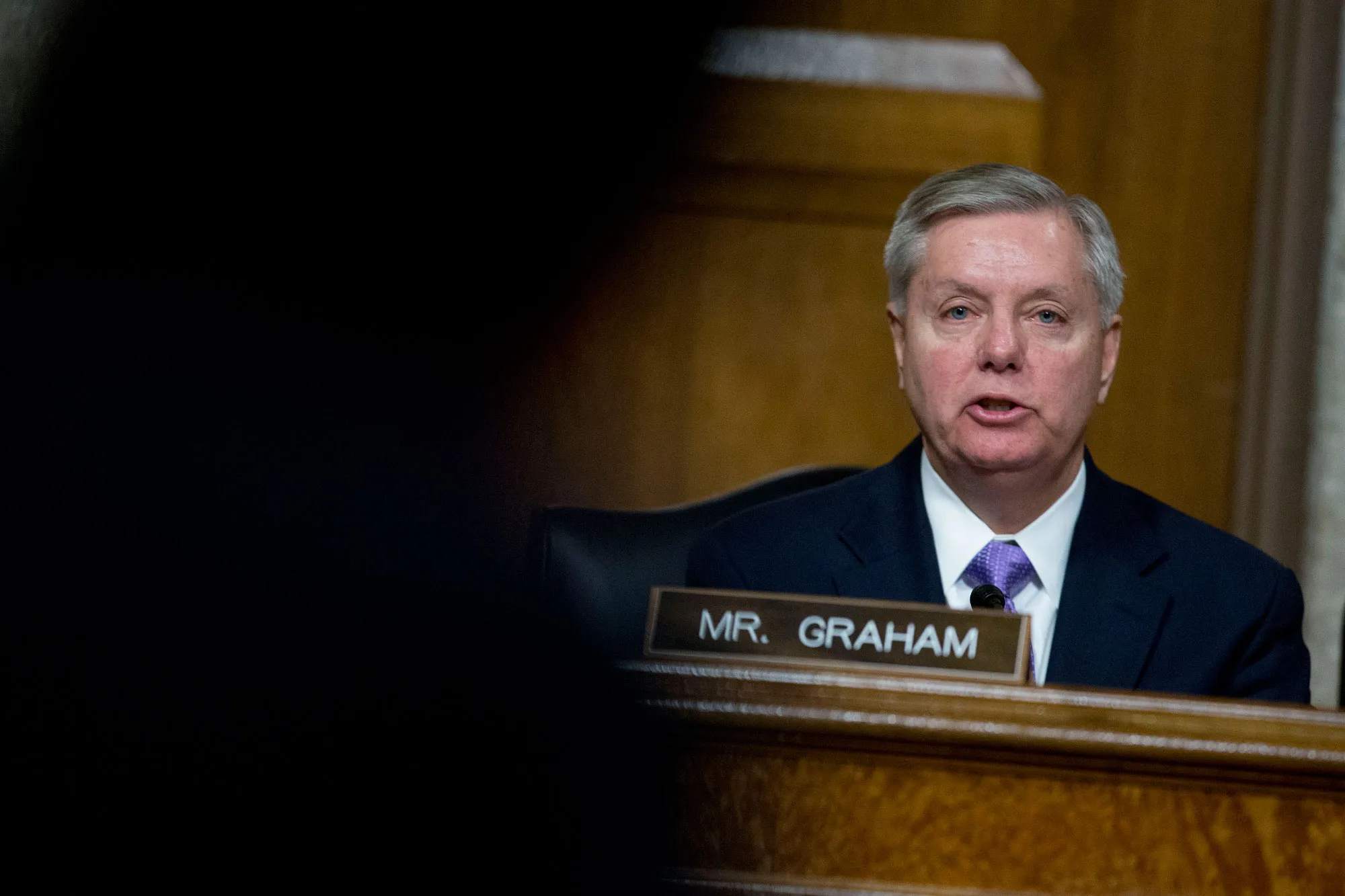 Senator Lindsey Graham, a Republican from South Carolina, questions Ashton Carter, former deputy secretary of defense and U.S. President Barack Obama's nominee to be U.S. secretary of defense, left, during a Senate Armed Services Committee nomination hearing in Washington, D.C., U.S., on Wednesday, Feb. 4, 2015.
