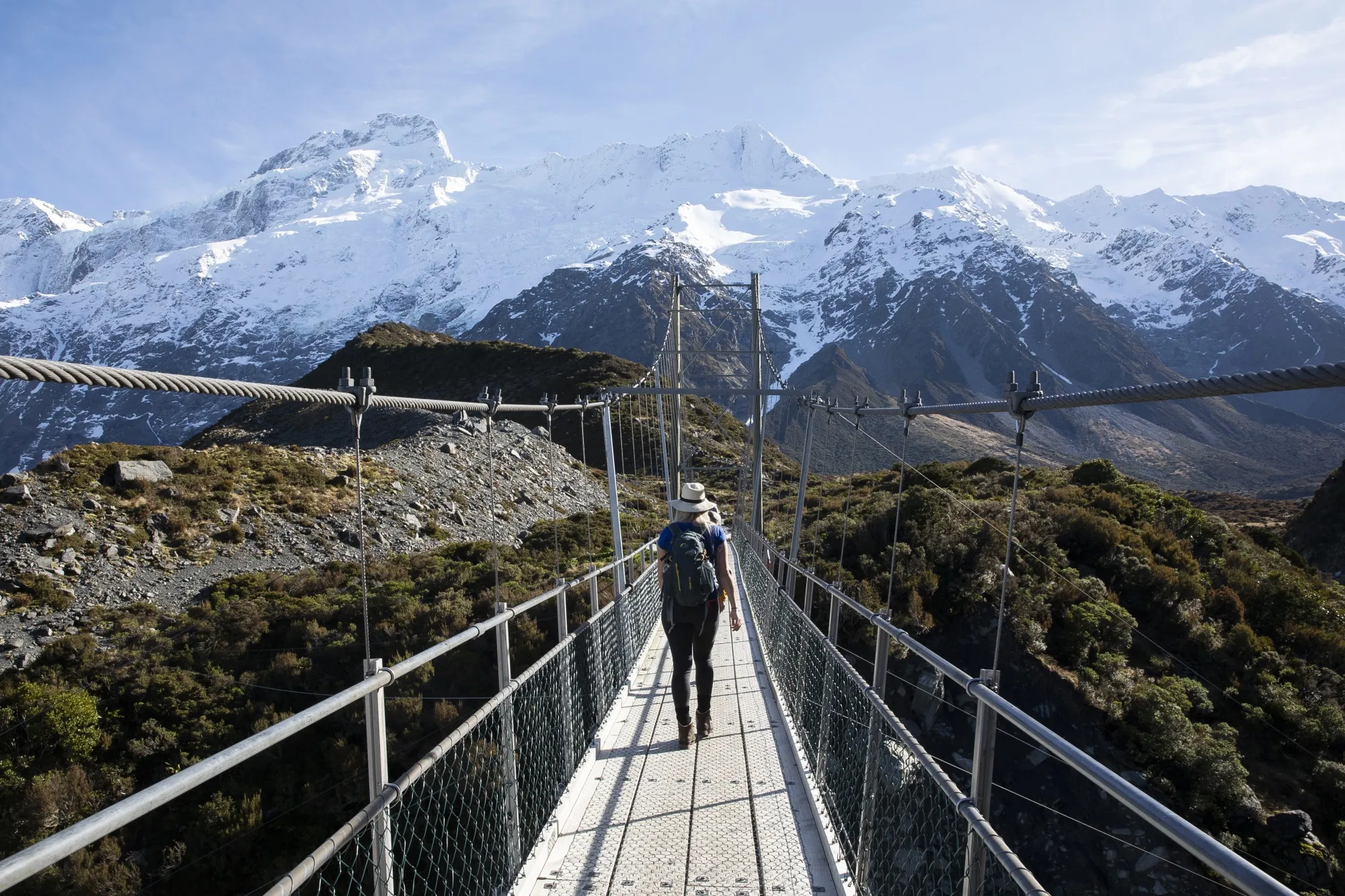Hikers walk in the Hooker Valley track in the Mount Cook National Park, New Zealand.