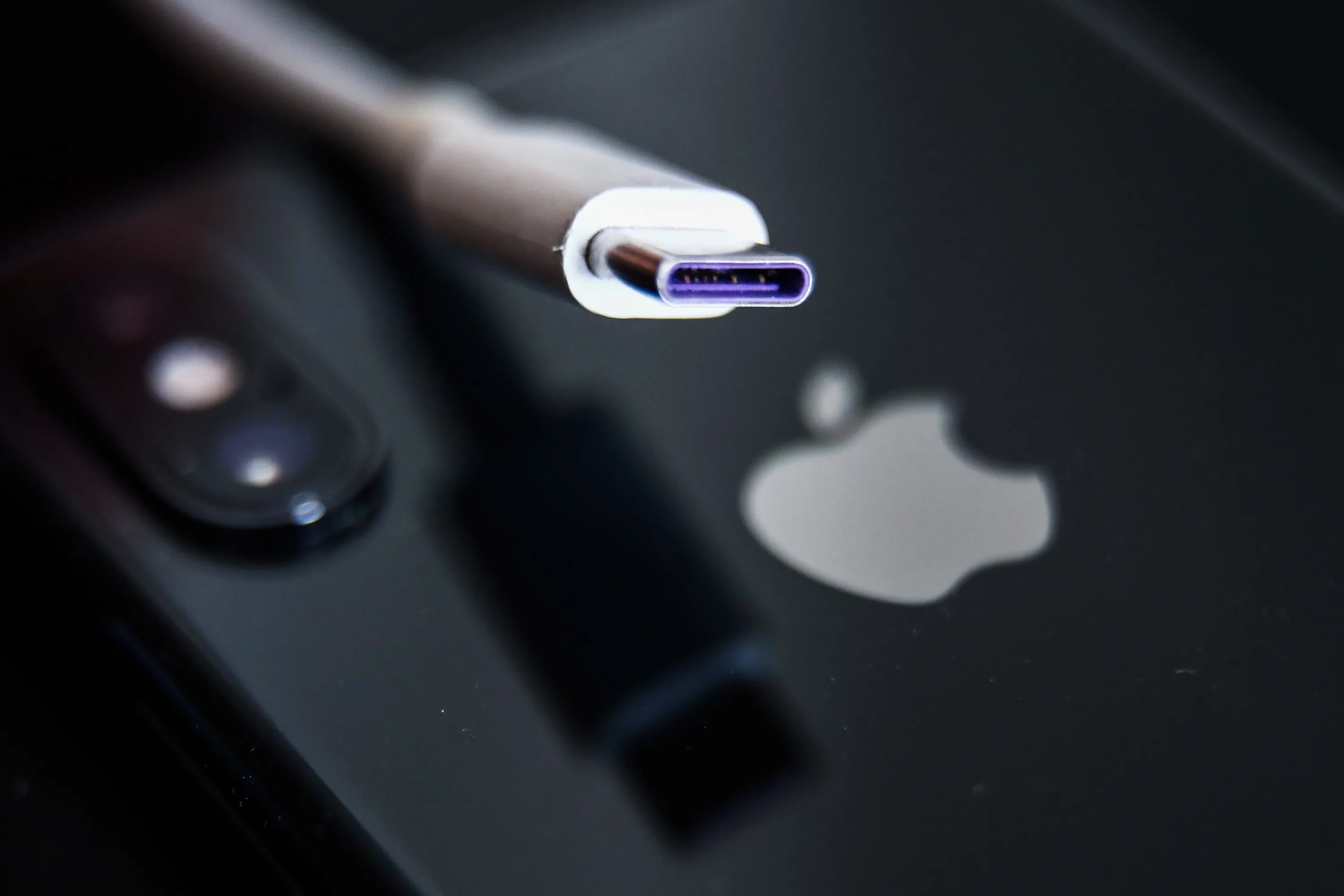 A USB-C cable and Apple Inc. iPhone.