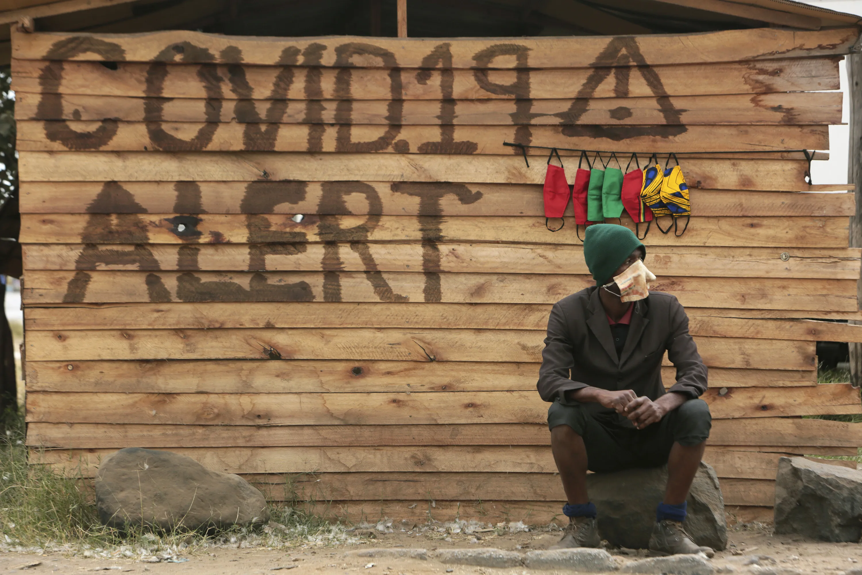 A man sells face masks for use to curb the spread of coronavirus outside a makeshift shop in Harare, Zimbabwe.&nbsp;