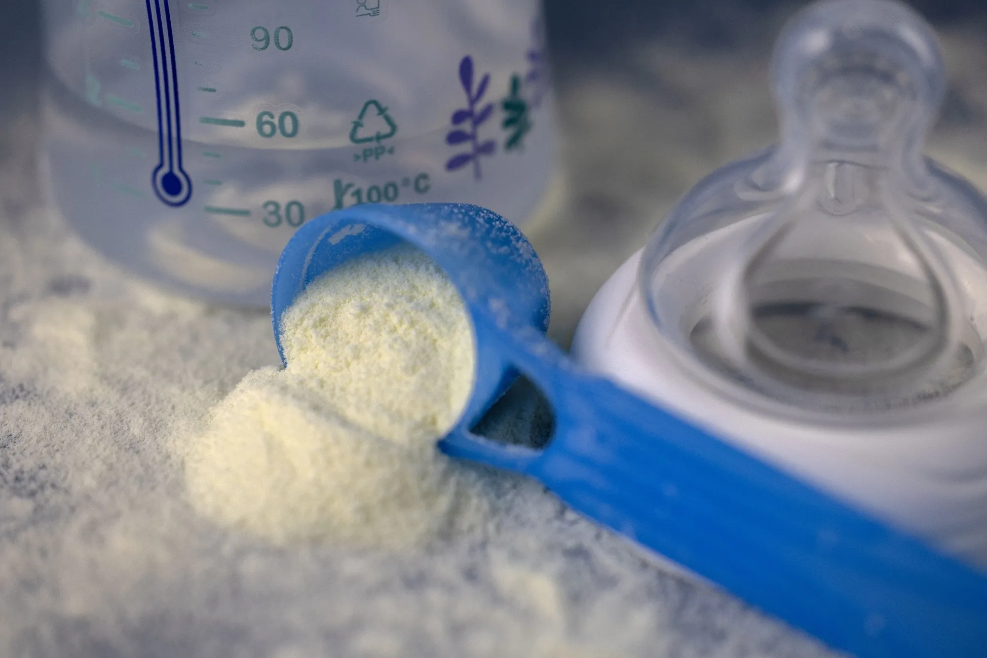 Infant milk formula and an infant feeding bottle arranged in Quimper, France on Jan. 29. The infant formula recall&nbsp;enters a new legal phase with a complaint filed at the Paris Judicial Court by consumer group Foodwatch.
