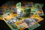 Australian one hundred dollar and fifty dollar banknotes are arranged for a photograph in Sydney.