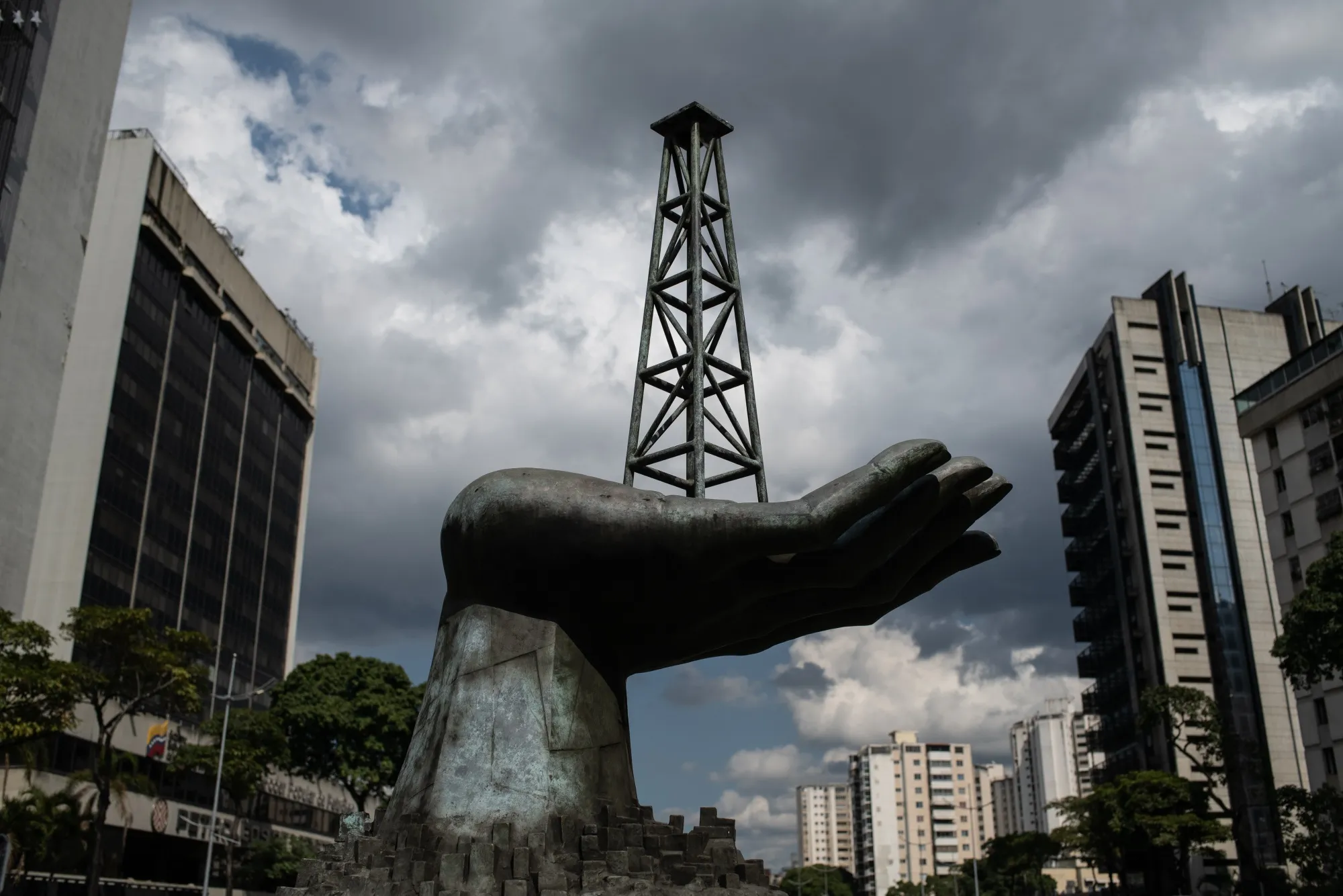 A sculpture of a hand holding an oil well outside Petroleos de Venezuela SA (PDVSA) headquarters in Caracas, Venezuela.