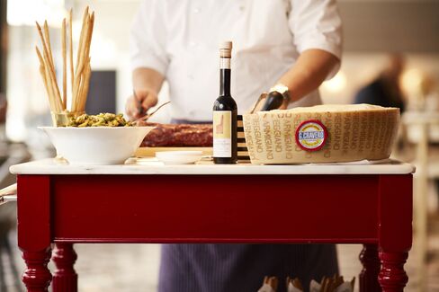 The roving antipasti cart at La Sirena is loaded with aged Parmigiano, marinated olives, salami, and grissini.