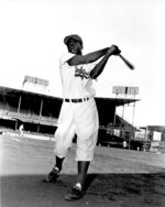 Jackie Robinson, infielder for the Brooklyn Dodgers, swings his bat in this action pose at Ebbett's Field in Brooklyn, N.Y., on May 9, 1951. A plaque honoring baseball legend Jackie Robinson that was vandalized in Georgia is coming to Kansas City's Negro Leagues Baseball Museum to be put on display. The sign was erected in 2001 outside the birthplace of Robinson near Cairo, Georgia. Community members there discovered last year that someone had shot the plaque multiple times. (AP Photo File)