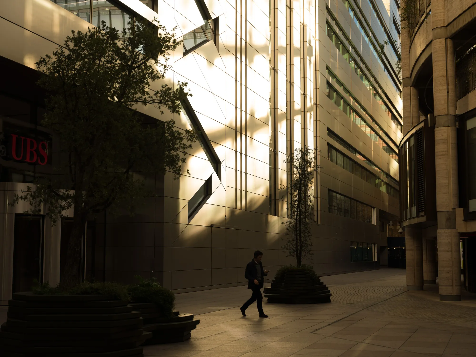 A pedestrian walks past the UBS Group AG U.K. headquarters in the City of London.