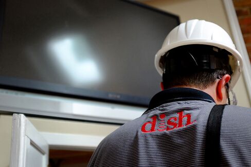 A DISH Network field service specialist installs a satellite television system at a home in Denver, CO on August 6, 2013.