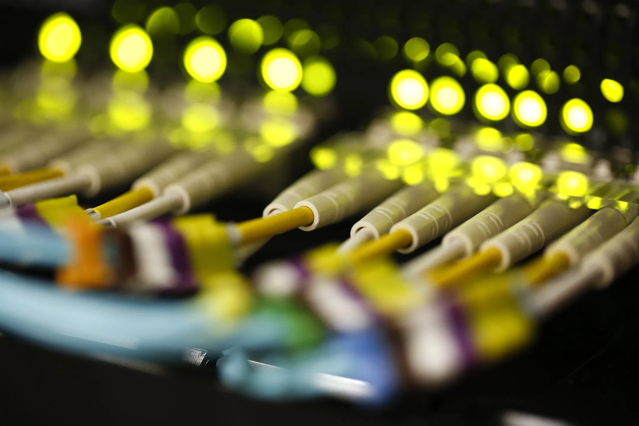 Rows of fibre optic cables are seen feeding into computer server inside a comms room at an office in London, U.K.
