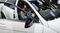 A visitor poses for a photograph in a Mercedes Benz C-Class vehicle, during the 12th Auto Expo 2014 in Noida, India.