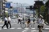 Pedestrians and cyclists cross a road in Matsue, Shimane Prefecture.