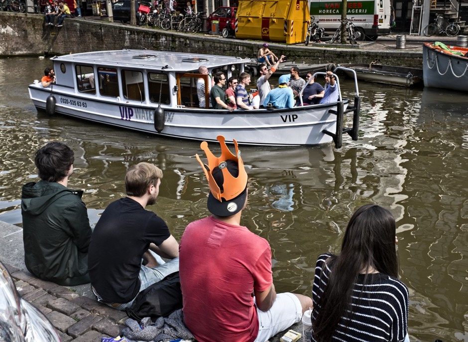 Revelers sail on a canal in downtown Amsterdam for a King's Day celebration. Amsterdam has considered banning drinking on boats to cut down noise and nuisance on its canals.