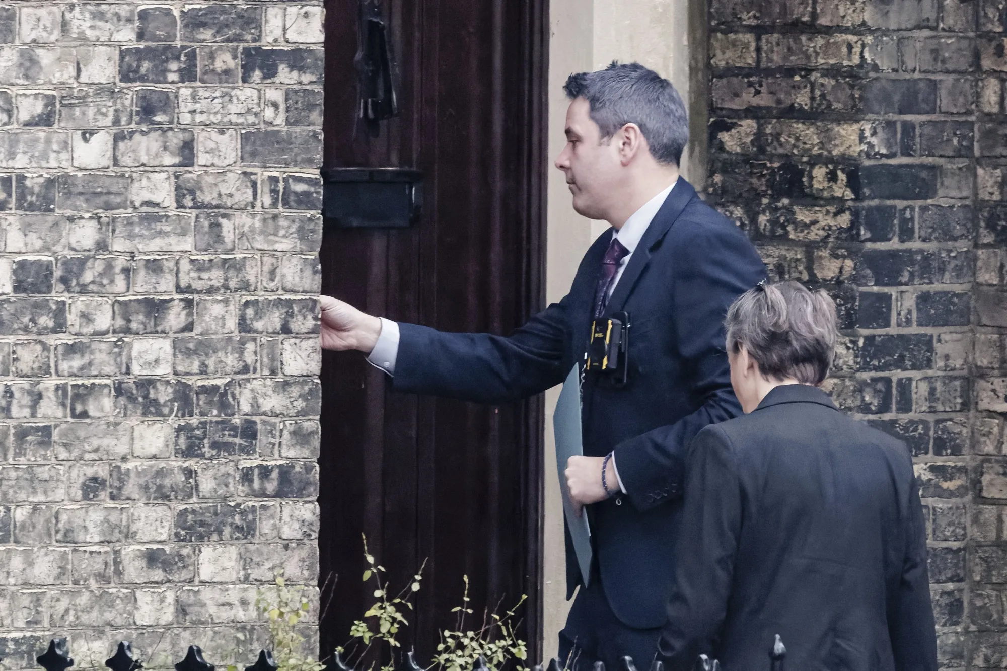 Two people believed to be police officers arrive at the home of Lord Peter Mandelson in London on Feb. 6.