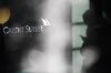 A Credit Suisse logo in the window of a Credit Suisse Group AG bank branch in Zurich, Switzerland, on Thursday, April 8, 2021. Credit Suisse Chief Executive Officer Thomas Gottstein gathered dozens of managing directors at the global bank on a conference call late Tuesday, as part of crisis-management efforts after the lender announced that it stands to lose as much as $4.7 billion amid the meltdown of hedge fund Archegos Capital Management.