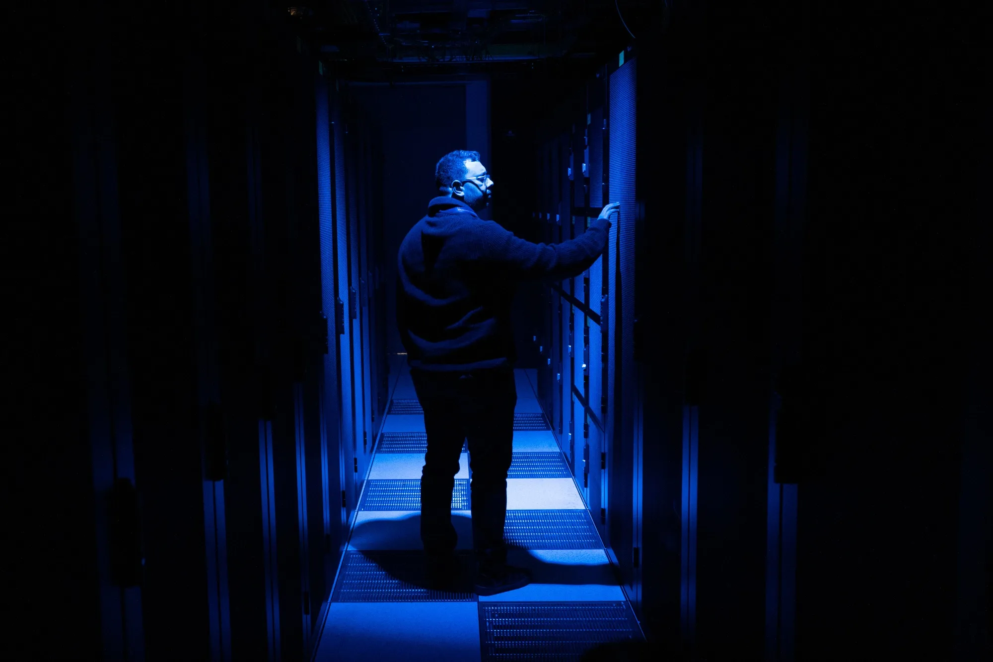 A visitor observes a computer bay at a data center in Paris, France.