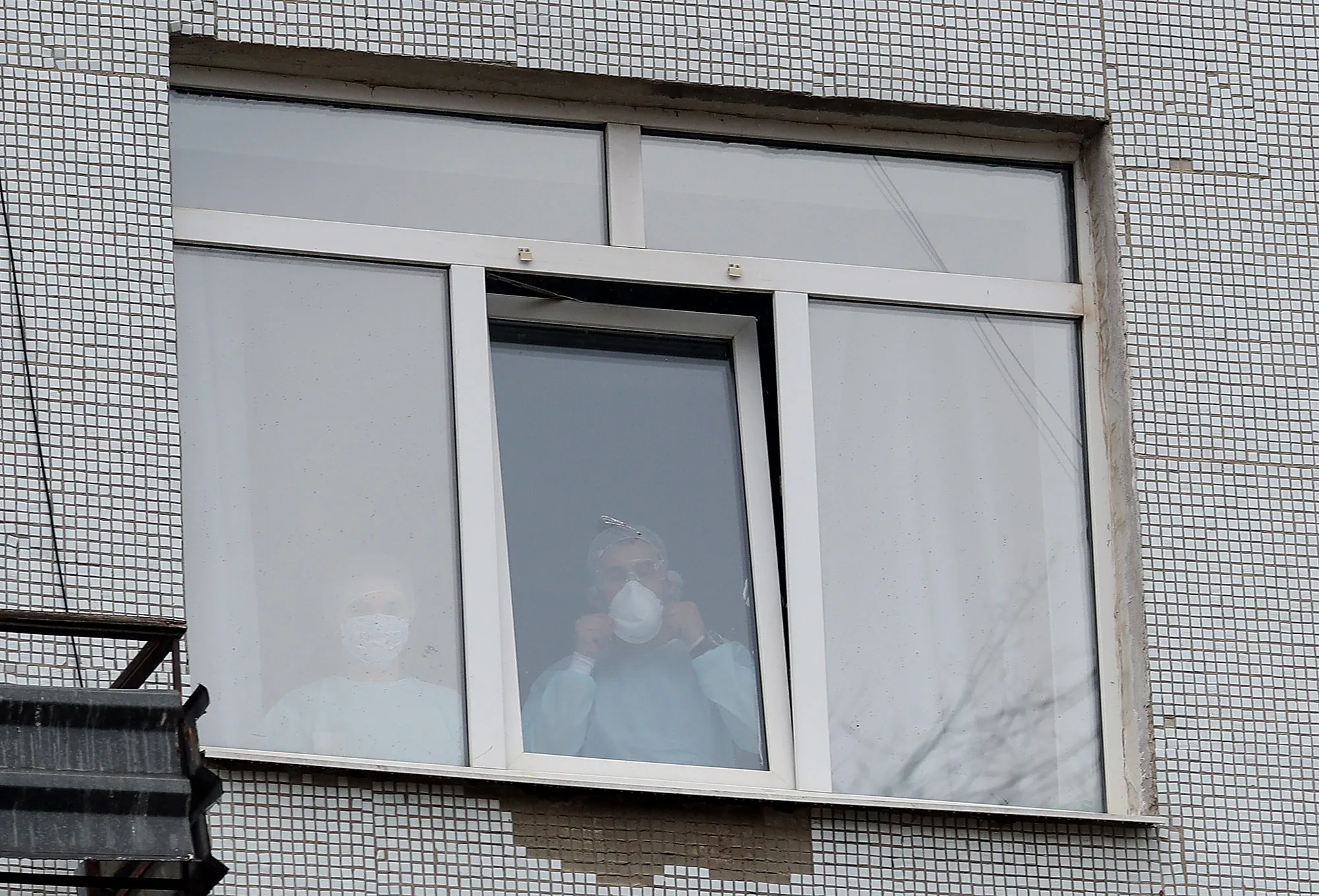 Medical workers look out of a window at Yekaterinburg’s No 1 Central Municipal Clinical Hospital on April 20.
