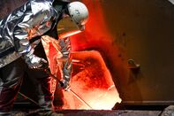 A worker collects a sample of molten steel at a metalworks in Germany.