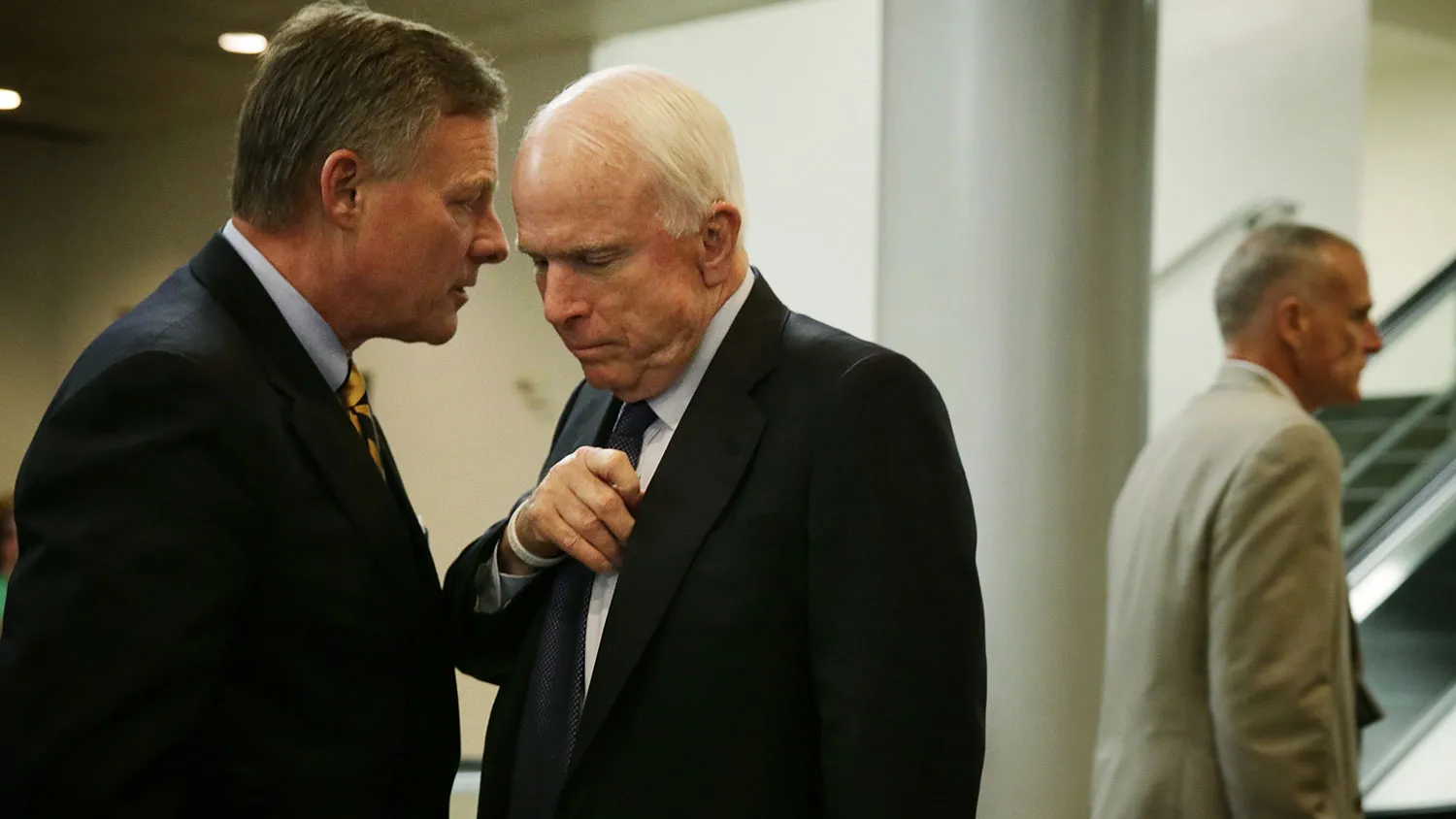 U.S. Sen. John McCain (R-AZ) (C) listens to Sen. Richard Burr (R-NC) (L) after a vote on Loretta Lynch to become the next U.S. Attorney General April 23, 2015 on Capitol Hill in Washington, DC.
