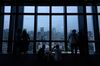 Visitors look out from the observation deck of the Tokyo Tower at dusk in Tokyo, Japan, on Thursday, Oct. 3, 2019. The vacancy rate for Tokyo office space will be announced on Oct. 10.